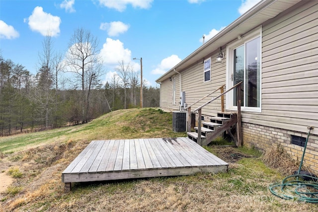 deck with central air condition unit, entry steps, and a yard