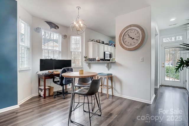 dining area featuring baseboards, plenty of natural light, and wood finished floors