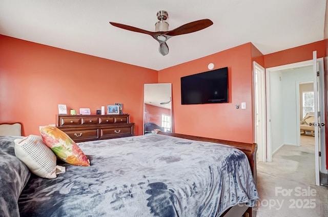 bedroom featuring a ceiling fan, baseboards, and light carpet