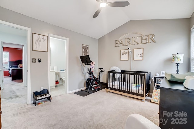 carpeted bedroom with connected bathroom, baseboards, ceiling fan, lofted ceiling, and a nursery area