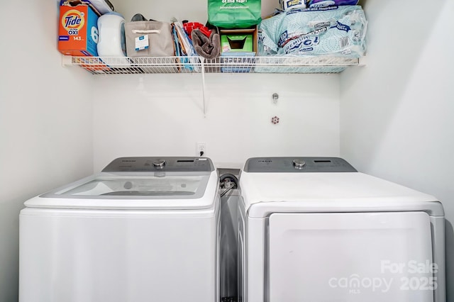 clothes washing area featuring laundry area and washer and dryer