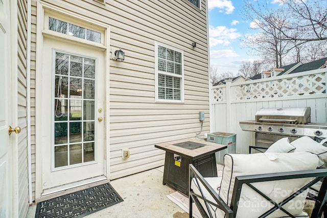 view of patio featuring area for grilling and fence