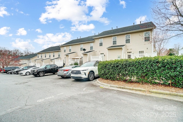 exterior space with a residential view and uncovered parking