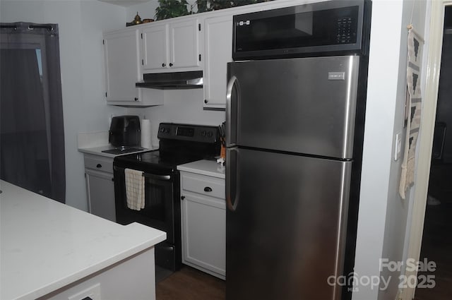 kitchen featuring freestanding refrigerator, light countertops, black electric range, white cabinets, and under cabinet range hood