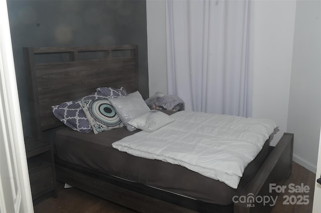 bedroom featuring wood finished floors