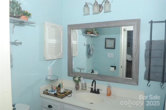 bathroom featuring toilet and vanity