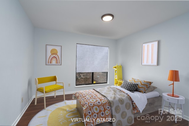 sitting room featuring baseboards and wood finished floors