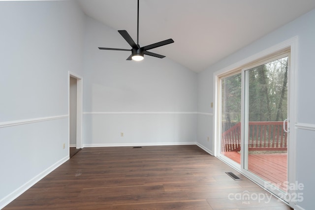 spare room with vaulted ceiling, wood finished floors, visible vents, and ceiling fan