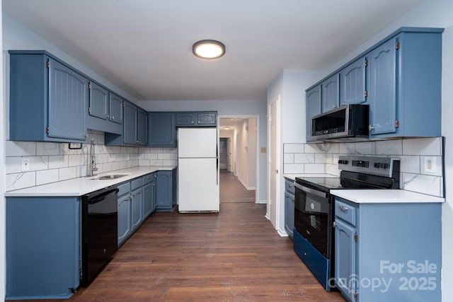 kitchen featuring blue cabinetry, black appliances, and a sink