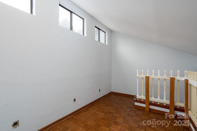 unfurnished room with baseboards