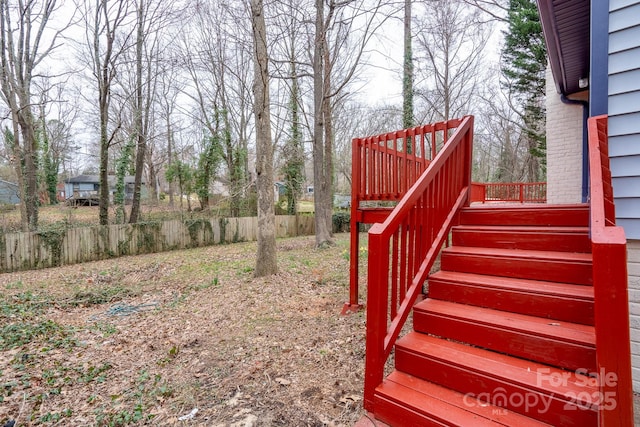 view of yard with stairs and fence