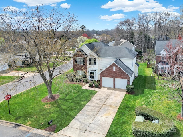 view of front facade featuring roof with shingles, concrete driveway, an attached garage, a front yard, and brick siding