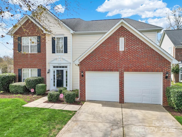 traditional home with concrete driveway, brick siding, and a front yard