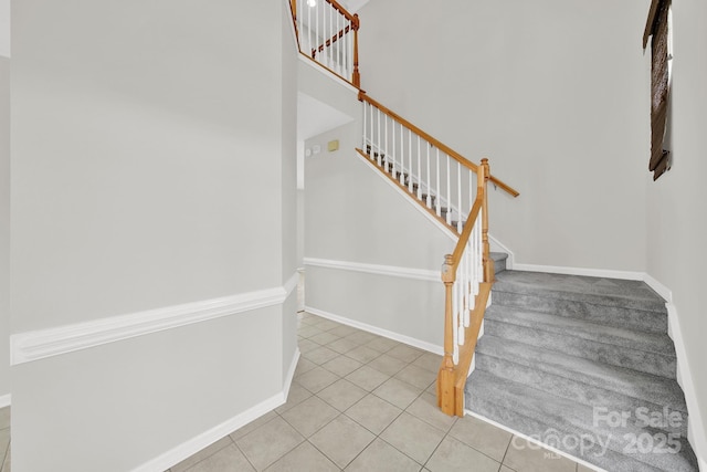 stairs with tile patterned flooring and baseboards