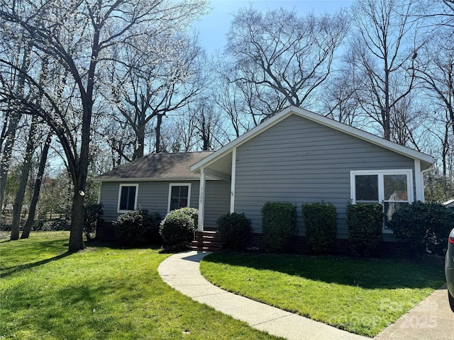 view of side of home featuring a yard