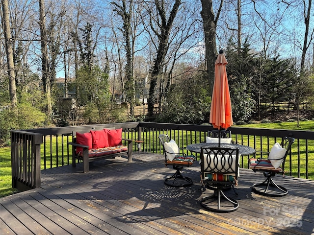 wooden terrace with a lawn