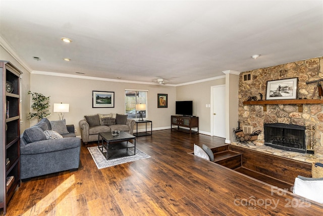 living area featuring hardwood / wood-style flooring, crown molding, a fireplace, baseboards, and ceiling fan