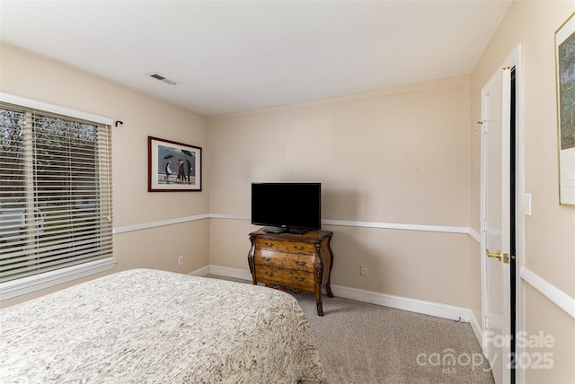 bedroom featuring visible vents, baseboards, and carpet