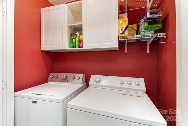 laundry area with cabinet space and independent washer and dryer