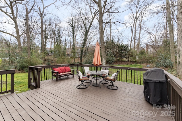 wooden terrace with outdoor dining area, a yard, and a grill