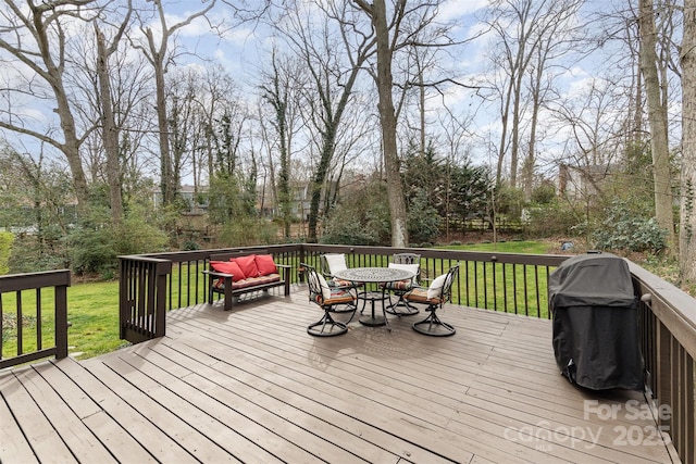 wooden deck featuring grilling area and a yard