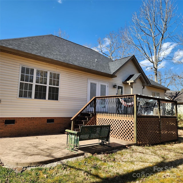 rear view of house with crawl space, french doors, a patio, and roof with shingles