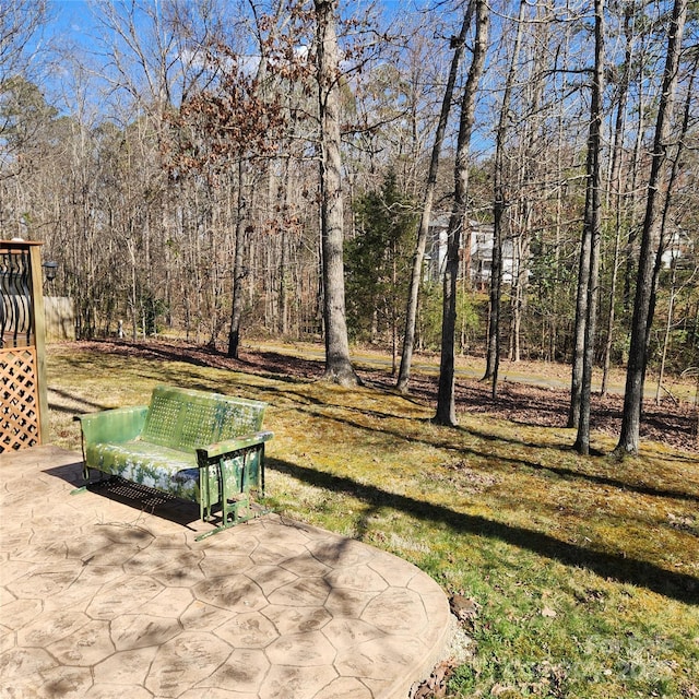 view of yard with a forest view and a patio