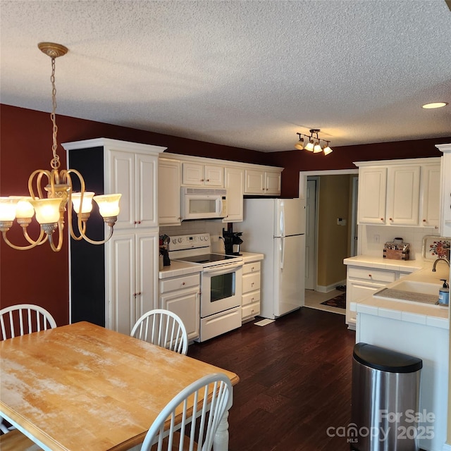 kitchen featuring tile countertops, dark wood-style floors, white appliances, and white cabinets