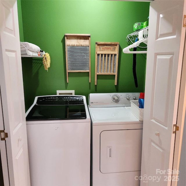 clothes washing area with laundry area and washer and dryer