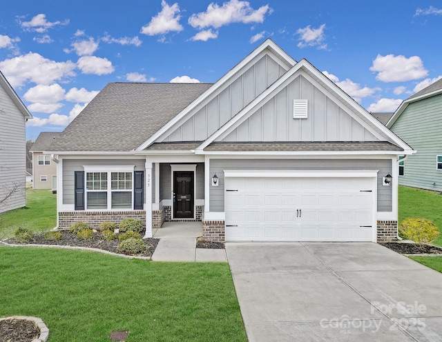 craftsman-style house featuring a front lawn, board and batten siding, concrete driveway, an attached garage, and brick siding