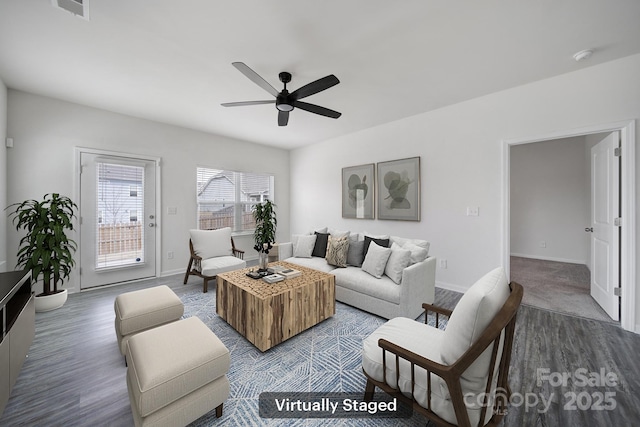 living room with visible vents, baseboards, a ceiling fan, and wood finished floors