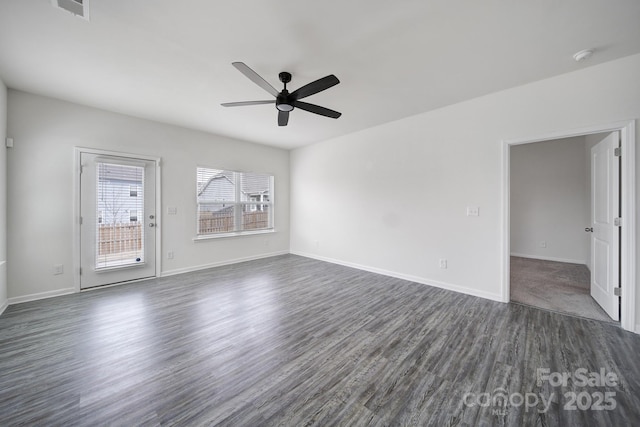 unfurnished room with dark wood-type flooring, visible vents, baseboards, and ceiling fan