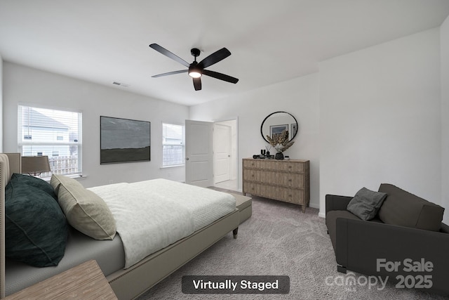 bedroom with a ceiling fan, visible vents, and carpet floors