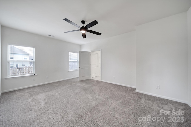 unfurnished bedroom featuring baseboards, visible vents, carpet floors, and ceiling fan