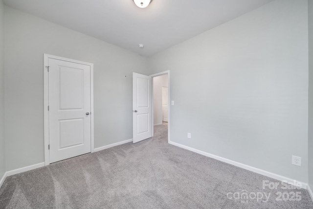 unfurnished bedroom featuring baseboards and carpet floors