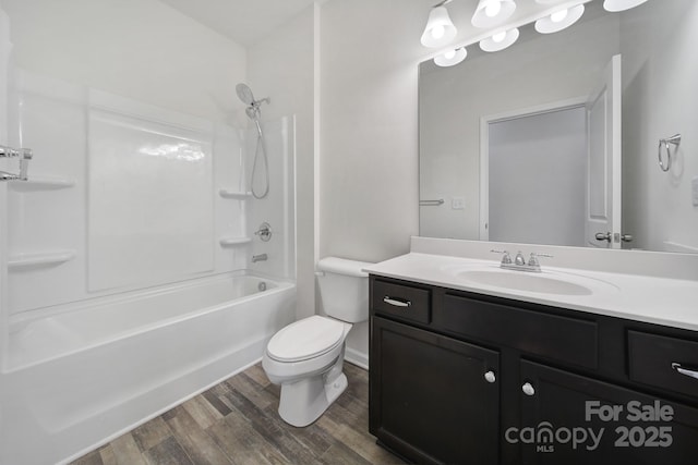 bathroom with bathing tub / shower combination, toilet, wood finished floors, and vanity