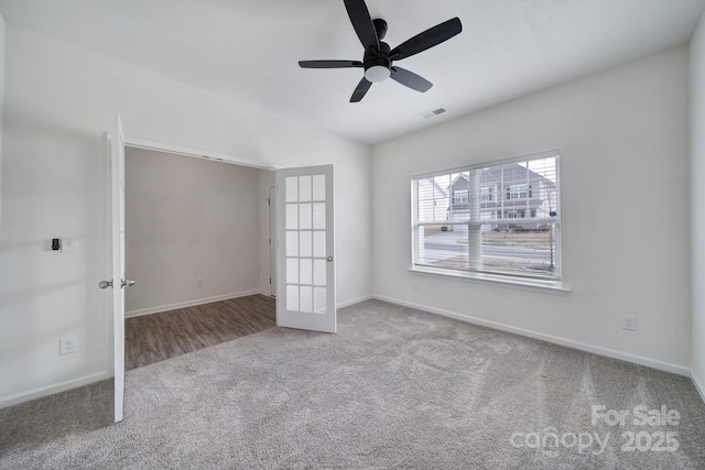 unfurnished bedroom featuring baseboards, french doors, carpet floors, and visible vents