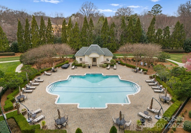 pool with a patio and fence