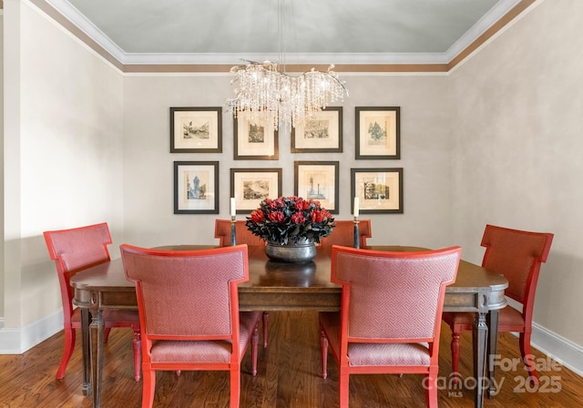 dining space with ornamental molding, baseboards, an inviting chandelier, and wood finished floors