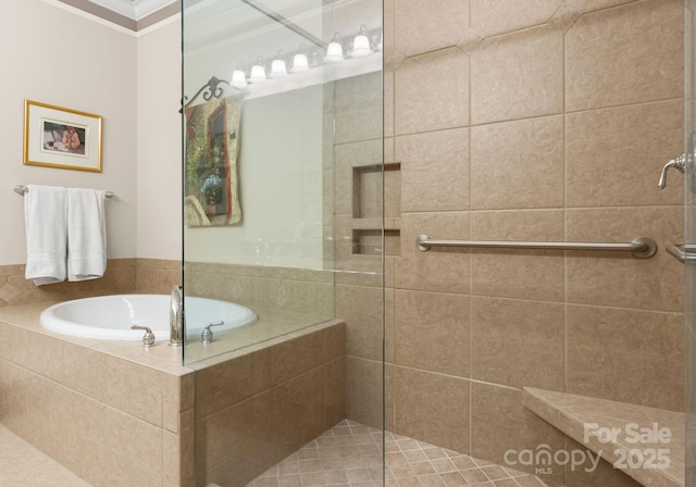 bathroom with crown molding, a bath, and tiled shower