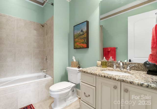 bathroom with tiled shower / bath, toilet, crown molding, tile patterned flooring, and vanity