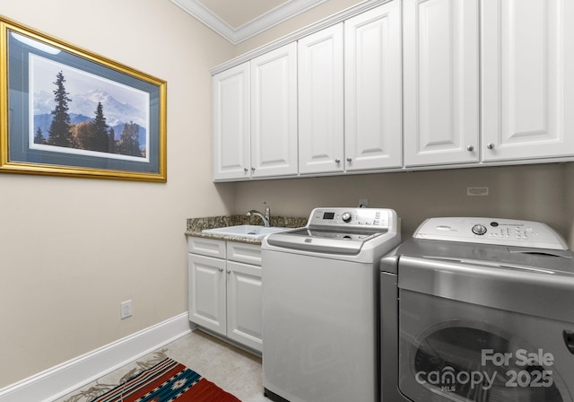 washroom with washer and clothes dryer, cabinet space, crown molding, and a sink