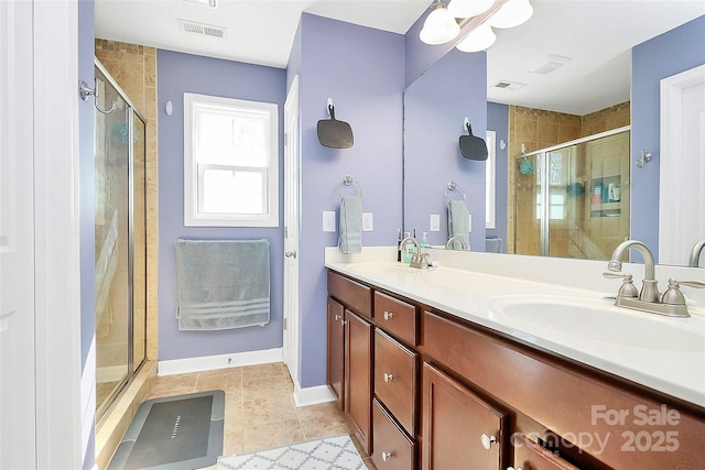 full bath featuring double vanity, visible vents, a shower stall, and a sink