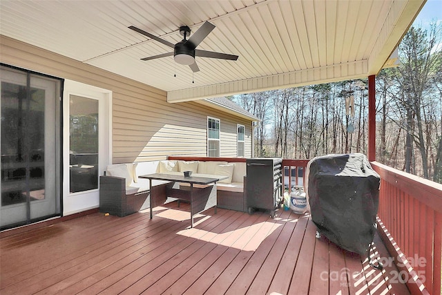 wooden deck with an outdoor living space and ceiling fan