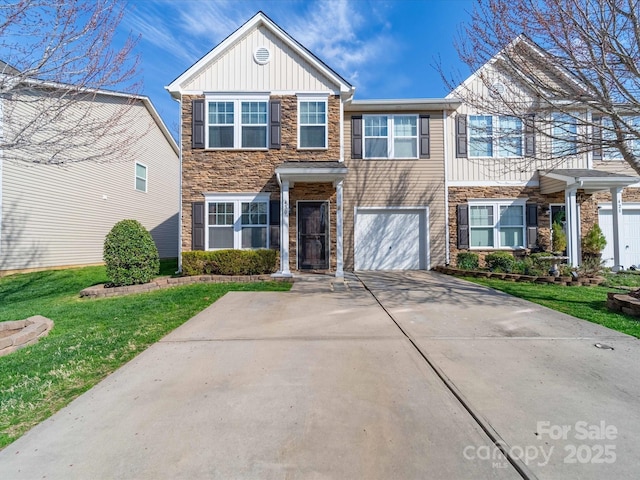 430 Battery Cir, Clover, SC 29710 - view of front of property featuring a front lawn, driveway, stone siding, board and batten siding, and a garage