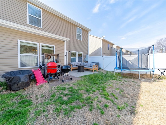 430 Battery Cir, Clover, SC 29710 - rear view of house with an outdoor living space, a trampoline, fence, a yard, and a patio area