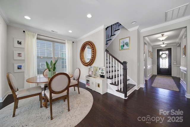 dining room with stairway, visible vents, and wood finished floors