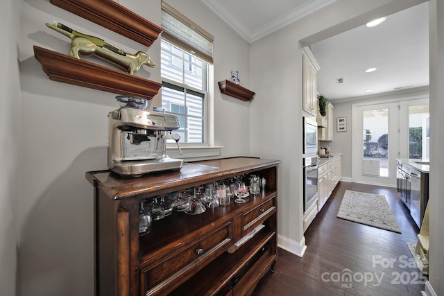 kitchen with crown molding, dark wood-type flooring, a wealth of natural light, white cabinets, and stainless steel appliances