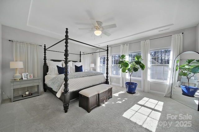 bedroom featuring visible vents, light colored carpet, baseboards, and ceiling fan