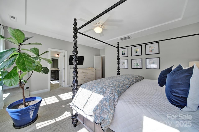 bedroom featuring visible vents, ceiling fan, baseboards, carpet, and ensuite bathroom